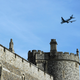 A Cathay Pacific passenger jet flies over Windsor Castle in London.